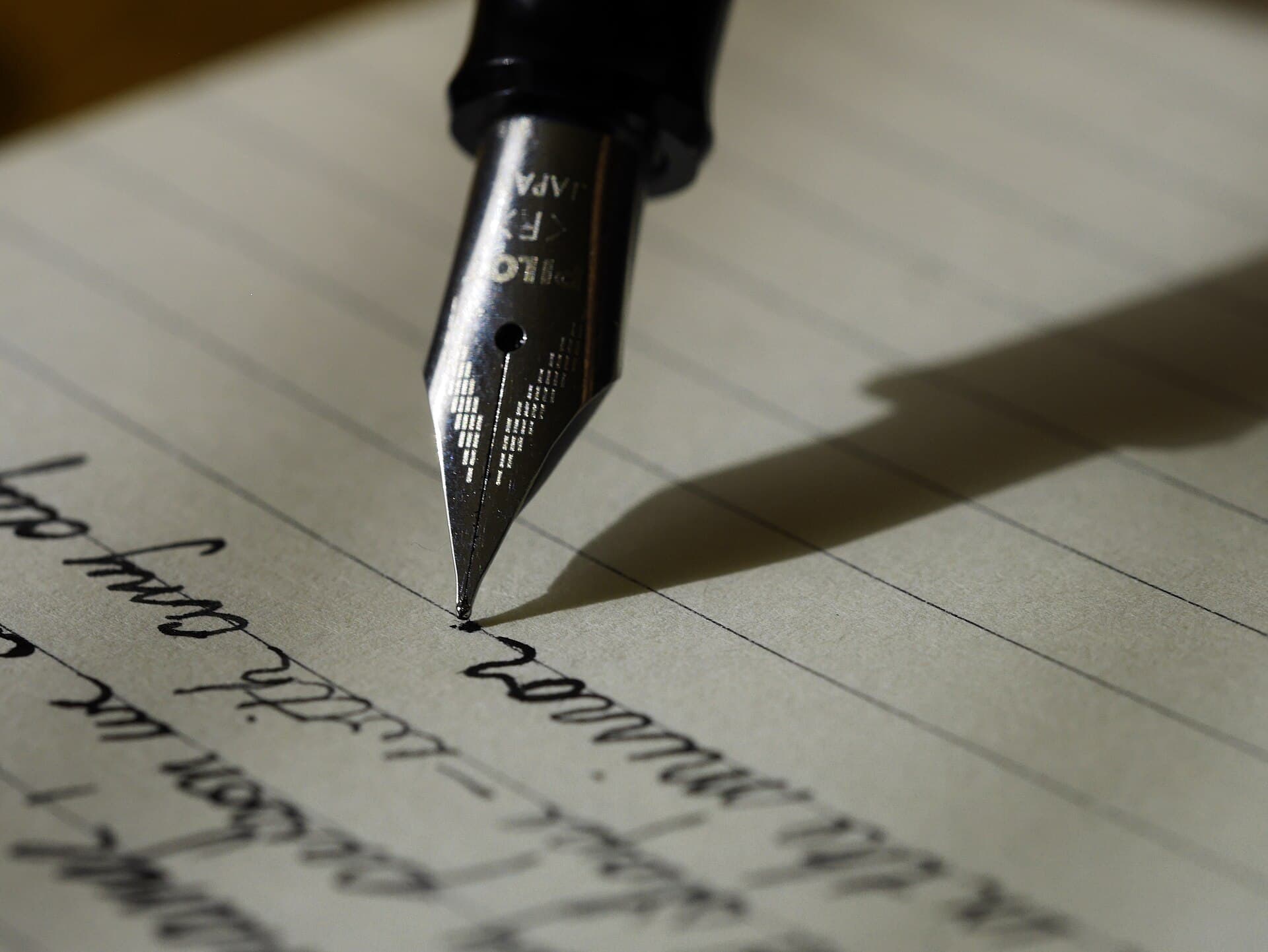 Fountain pen resting on a handwritten page